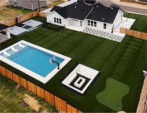 Yard with turf and a pool